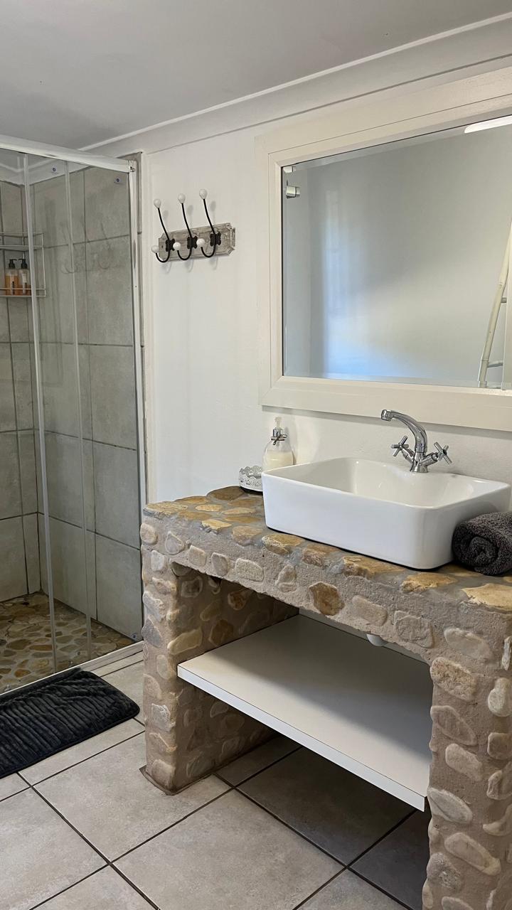 En-suite bathroom with stone vanity and walk-in shower at Sipreslaan