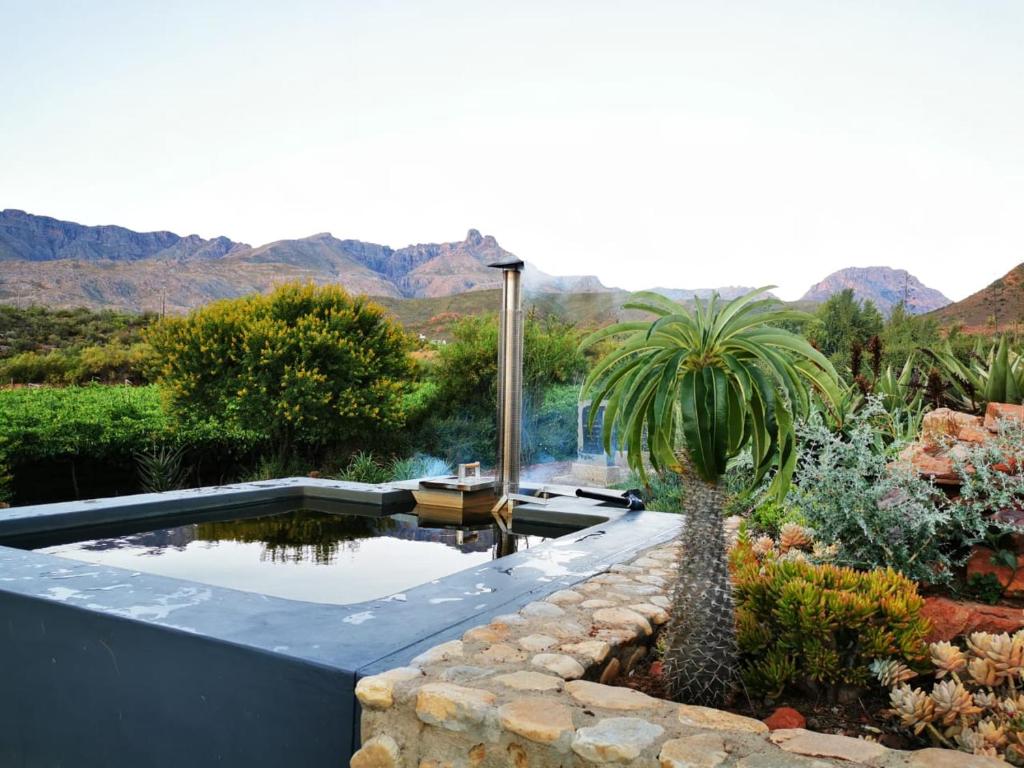 Wood-fired hot tub with Klein Karoo mountain views at Sipreslaan